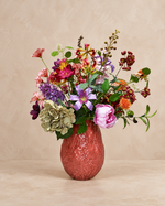 Zijdenboeket Colourful Garden inclusief roze vaas op warme beige achtergrond